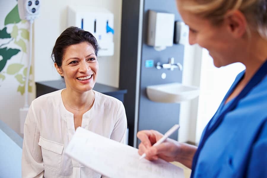 Doctor helping a patient fill out forms